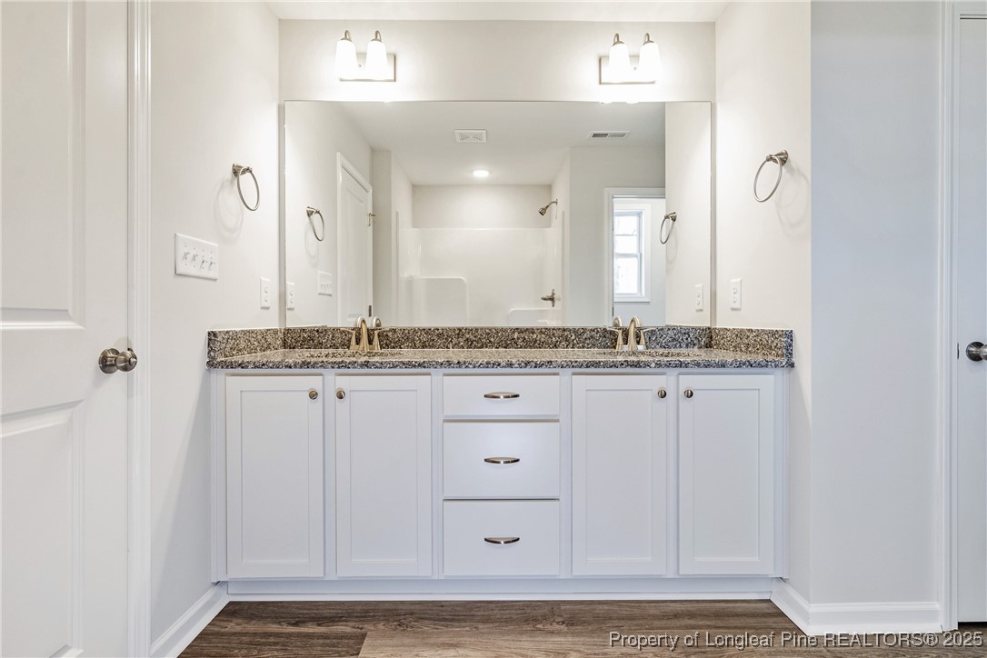 199 Palomo Place Raeford, NC 28376 - Photo 28 of 33 a bathroom with a granite countertop sink and a mirror