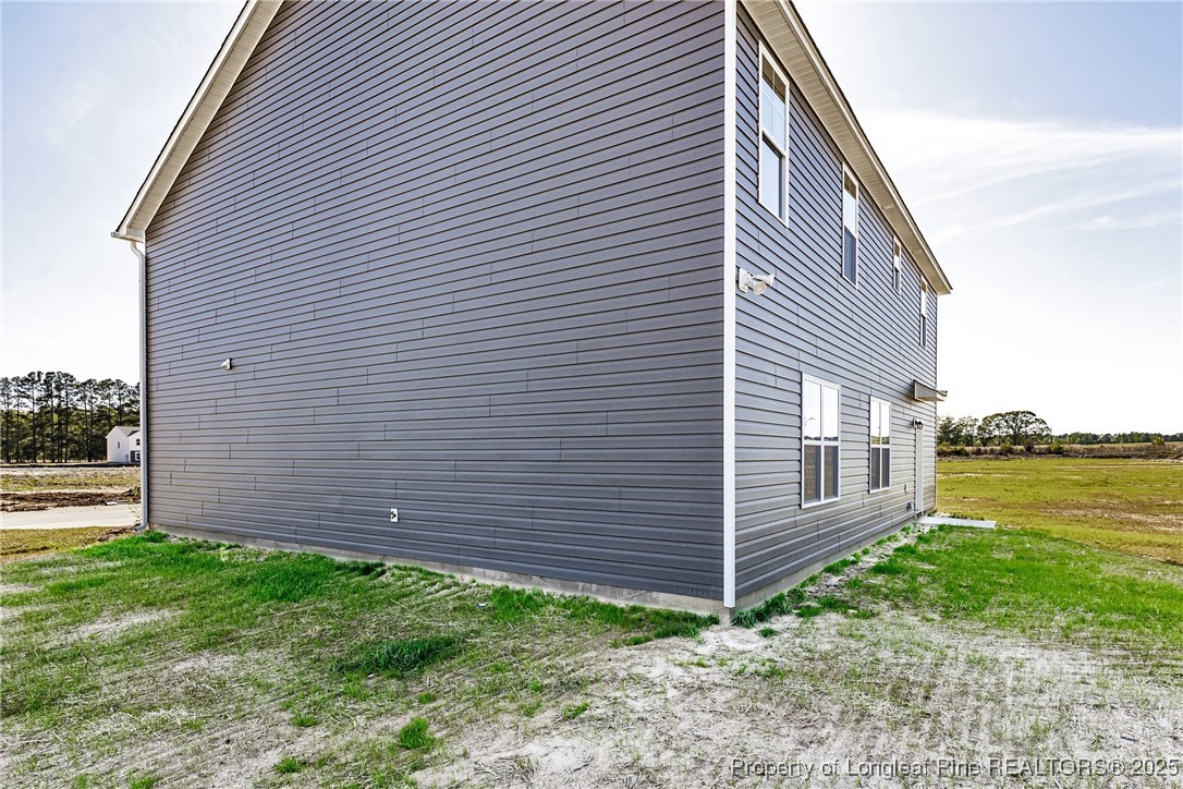 199 Palomo Place Raeford, NC 28376 - Photo 31 of 33 a view of a backyard with plants and large tree