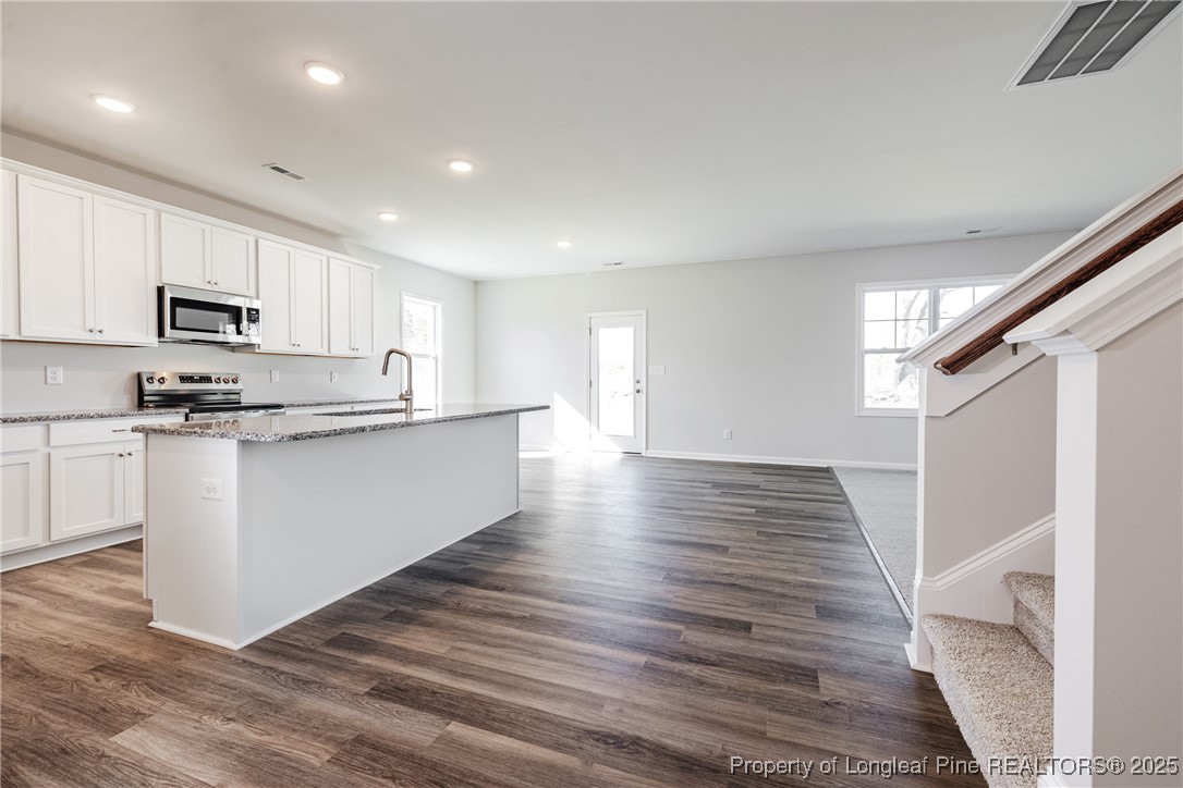 199 Palomo Place Raeford, NC 28376 - Photo 9 of 33 a kitchen with stainless steel appliances granite countertop a refrigerator sink and white cabinets