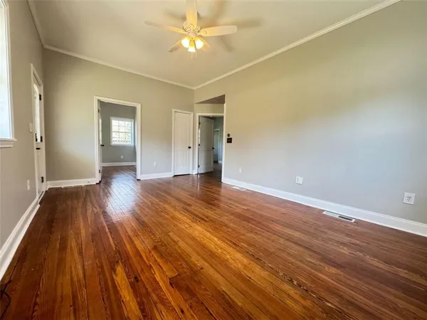 wooden floor in an empty room with a window