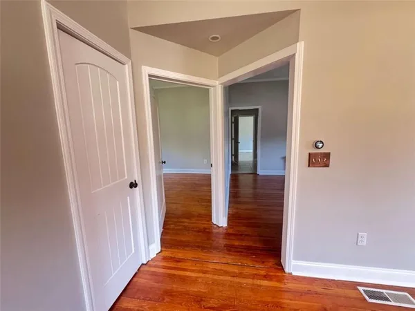 a view of a hallway with wooden floor