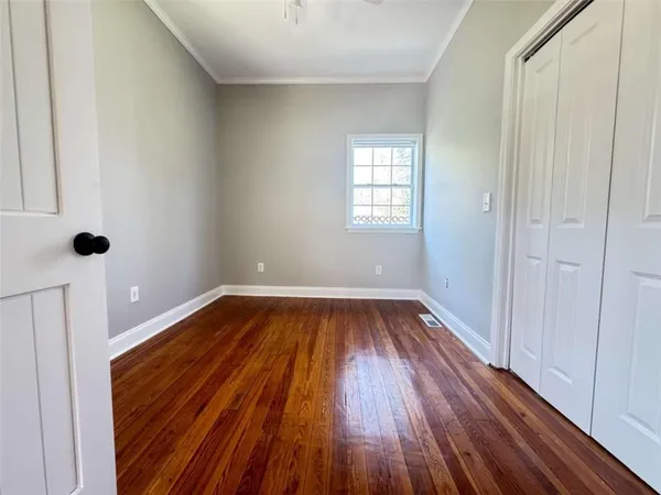 a view of a room with wooden floor and window