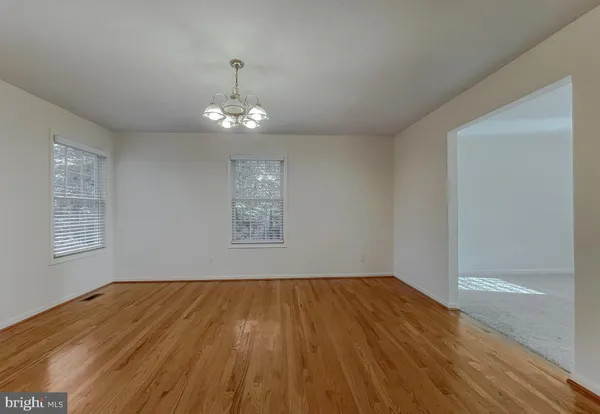a kitchen with granite countertop a sink cabinets and wooden floor