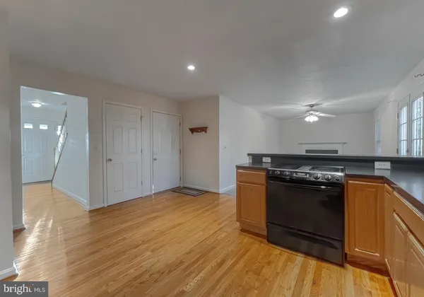 an empty room with windows and fireplace