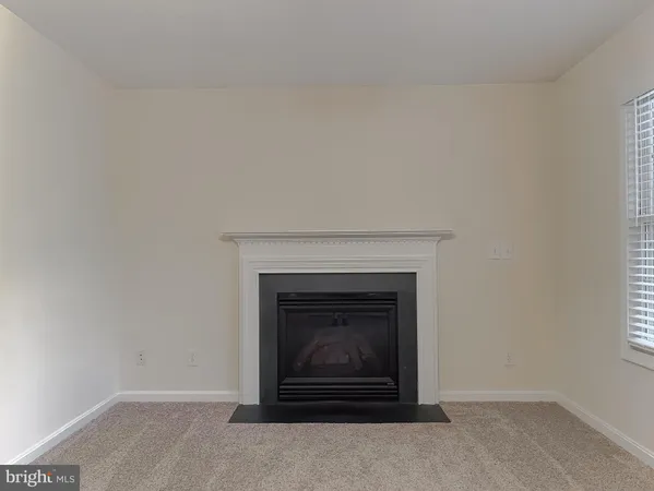 a view of an empty room with a chandelier