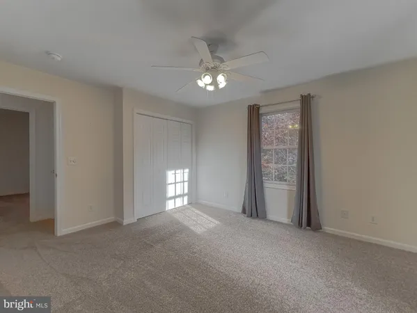 a view of an empty room with window and balcony