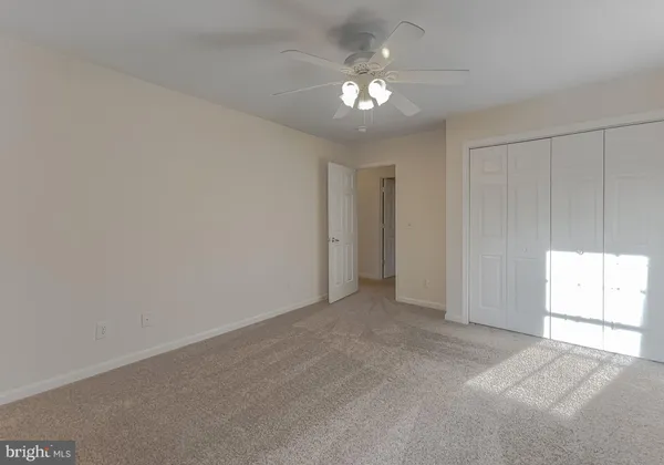 an empty room with windows and closet