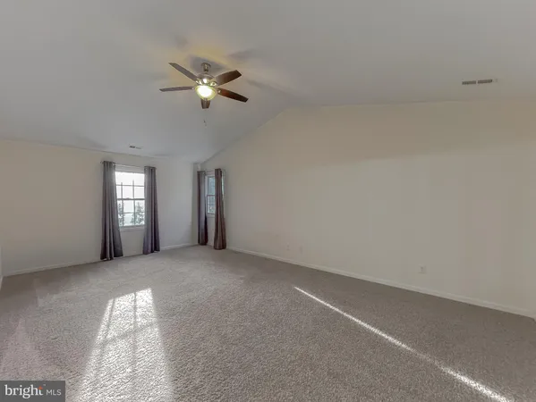 a view of an empty room with a fan