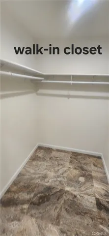 a kitchen with stainless steel appliances a refrigerator a sink a stove and white cabinets