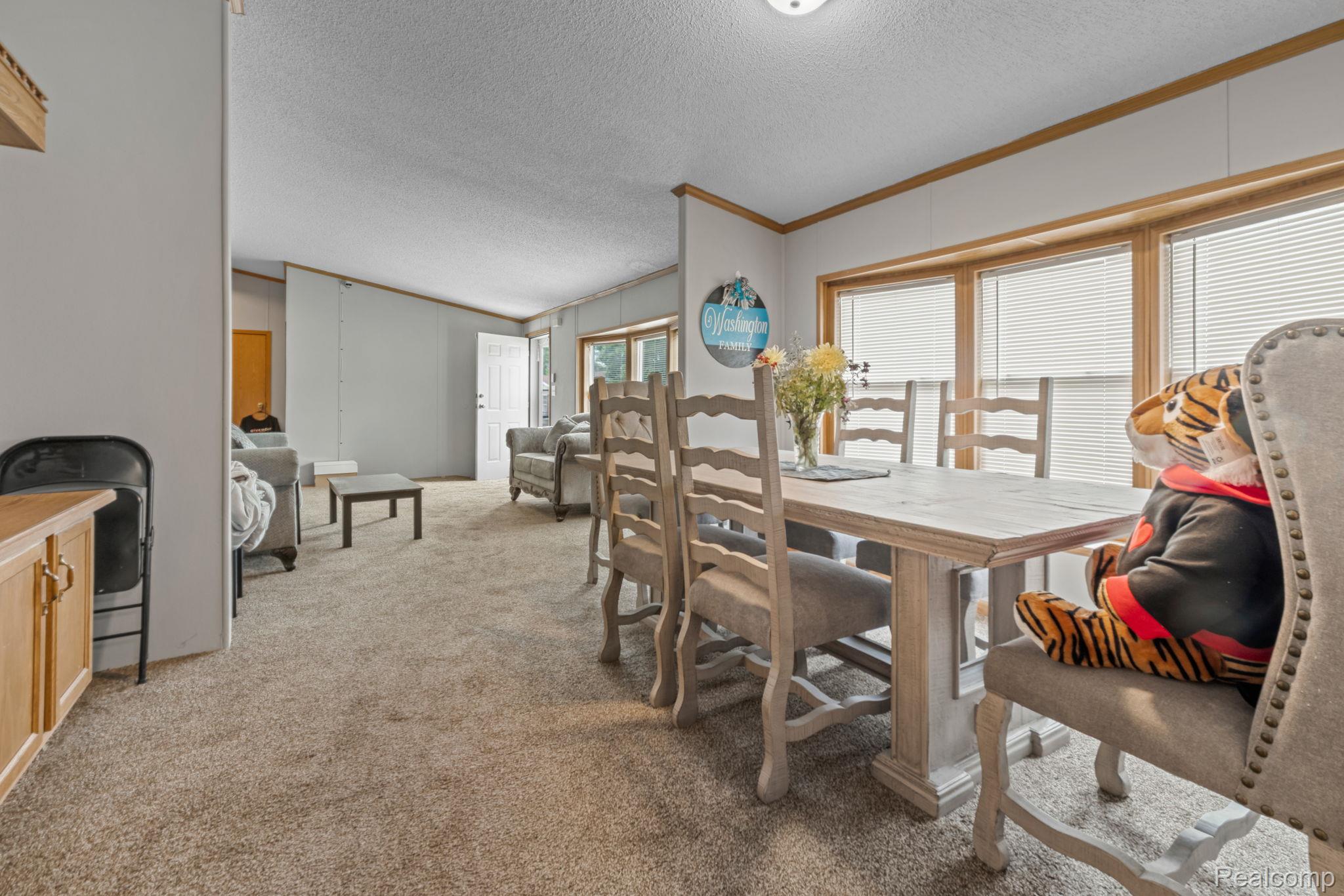 19921 Rhapsody Drive Clinton Township, MI 48036 - Photo 5 of 19 Carpeted flooring throughout, white interior walls, and wood-trim windows