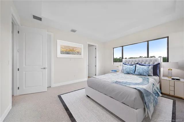 a spacious bedroom with a bed and a painting