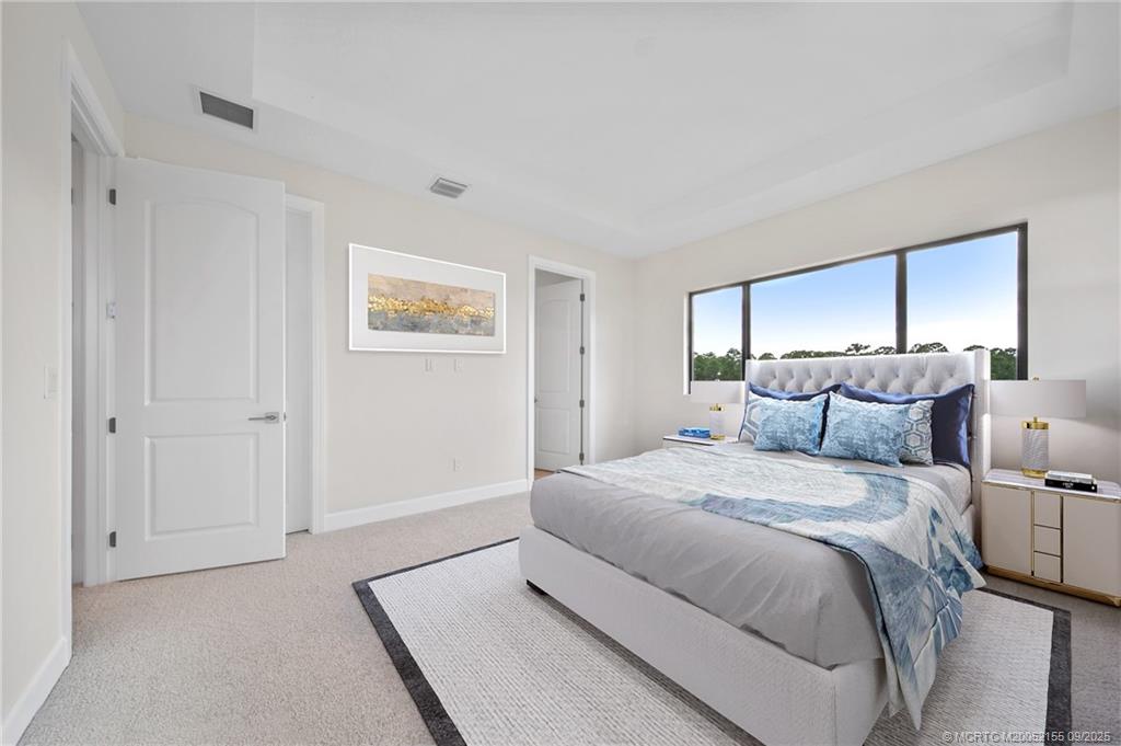3654 Southwest Magnolia Ridge Lane Palm City, FL 34990 - Photo 16 of 23 a spacious bedroom with a bed and a painting