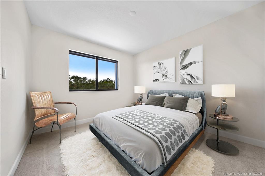 3654 Southwest Magnolia Ridge Lane Palm City, FL 34990 - Photo 21 of 23 a bedroom with a bed and a painting on the wall