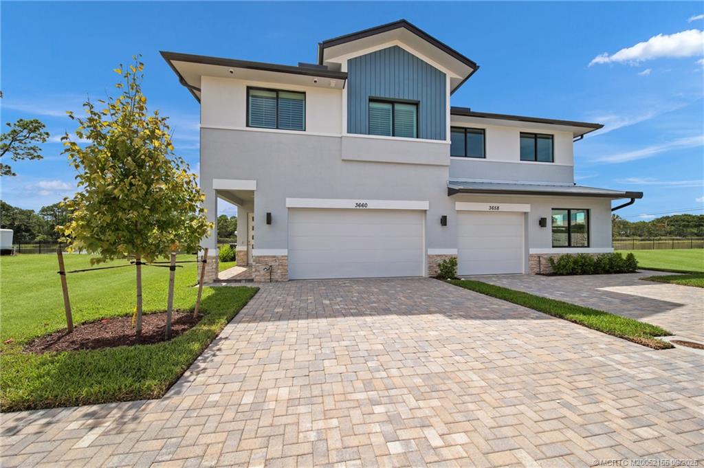 3654 Southwest Magnolia Ridge Lane Palm City, FL 34990 - Photo 23 of 23 a front view of a house with a yard and trees