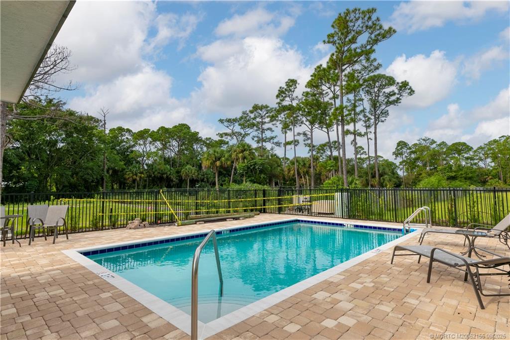 3654 Southwest Magnolia Ridge Lane Palm City, FL 34990 - Photo 7 of 23 a view of a lake with a patio