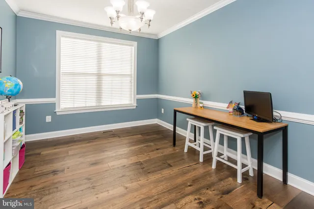 a kitchen with stainless steel appliances granite countertop wooden cabinets a stove a sink and dishwasher with wooden floor