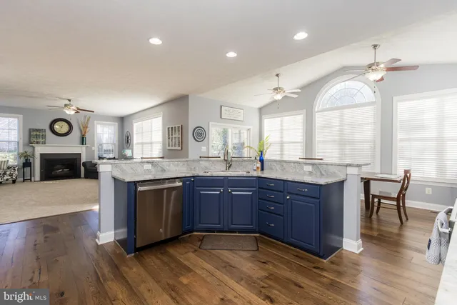 a living room with furniture and kitchen view