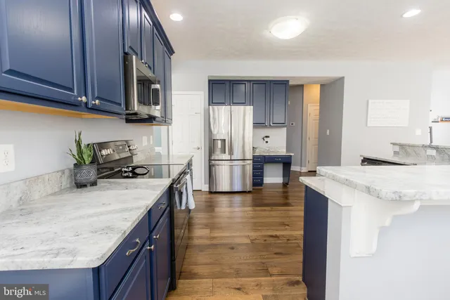 a living room with furniture a large window and a fireplace