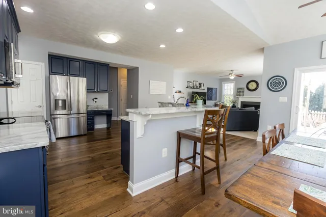 a bedroom with a bed and a lamp on dresser