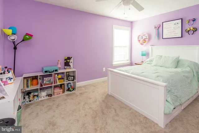 a living room with stainless steel appliances furniture a flat screen tv and a kitchen view