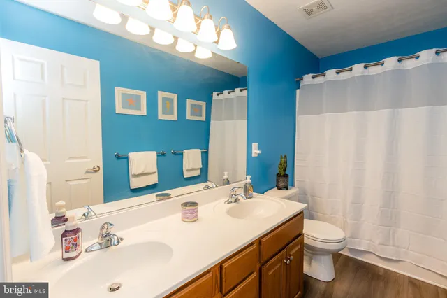 a bathroom with a sink a toilet and mirror