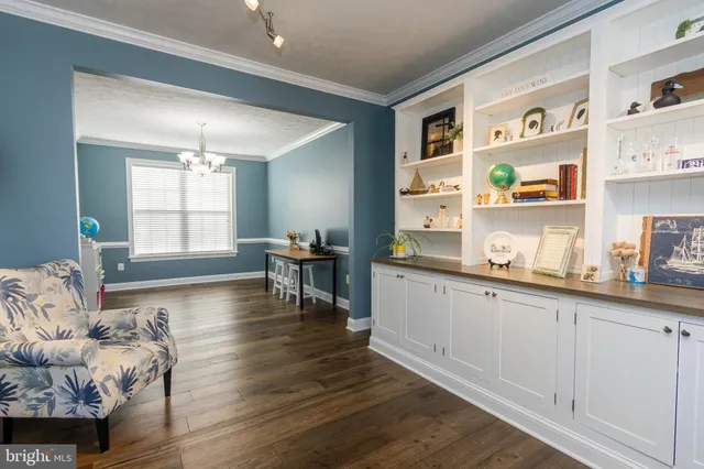 a living room with hard wood floors and a window