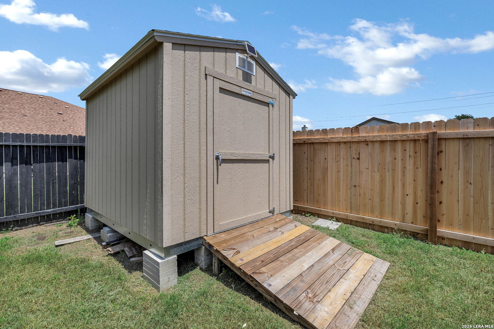 4015 Shervin Way Converse, TX 78109 - Photo 43 of 43 a backyard of a house with a yard and wooden fence