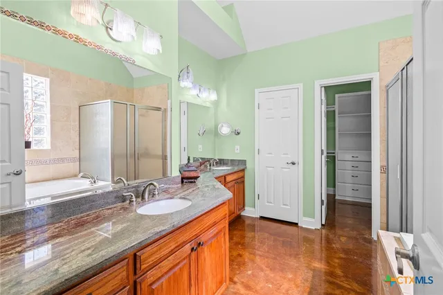 a bathroom with a sink double vanity and a mirror