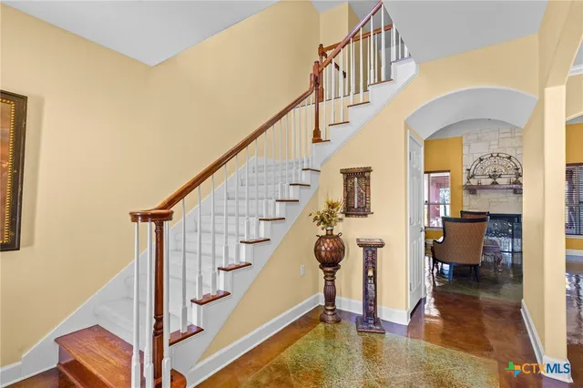 a view of entryway and hall with wooden floor