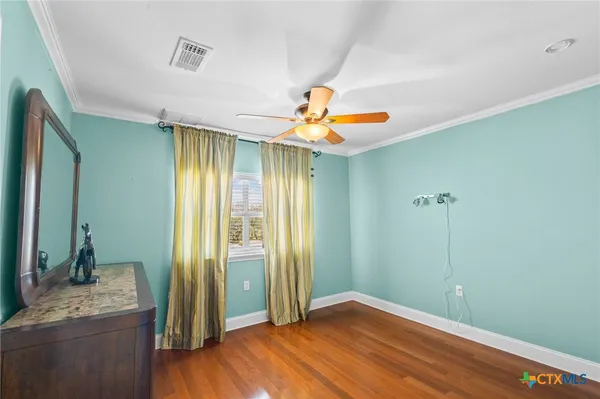 a view of a livingroom with a chandelier fan and a bathroom