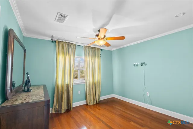 a view of a livingroom with a chandelier fan and a bathroom