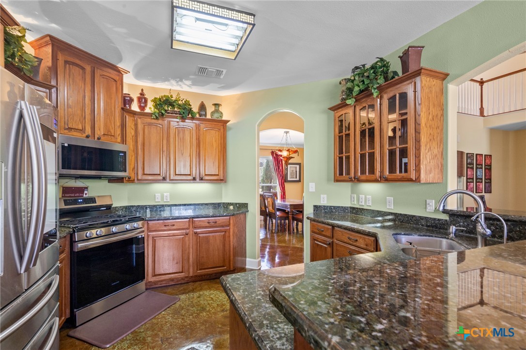 130 Post Oak Circle Inez, TX 77968 - Photo 3 of 48 a kitchen with stainless steel appliances granite countertop a stove a sink and a microwave