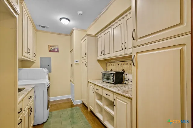 a kitchen with stainless steel appliances granite countertop a refrigerator and a stove