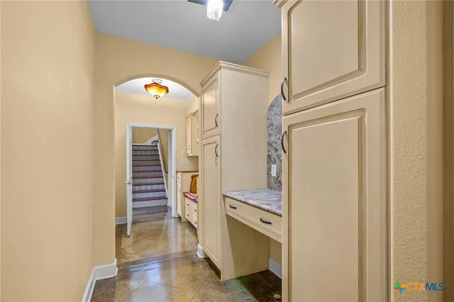 a view of hallway with stairs and wooden floor