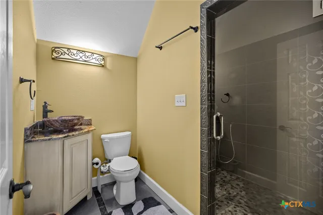 a bathroom with a toilet and a shower