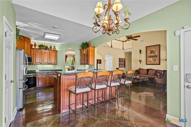 a view of a dining room with furniture a chandelier and wooden floor