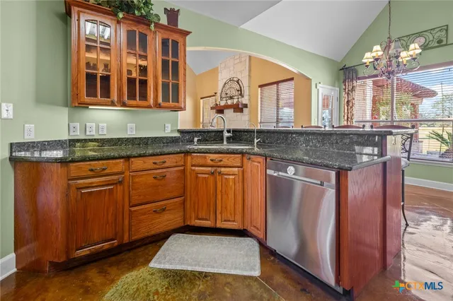 a kitchen with granite countertop a sink cabinets and window