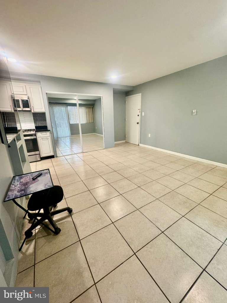 9278 Adelphi Road, Unit 103 Hyattsville, MD 20783 - Photo 14 of 24 a living room with furniture