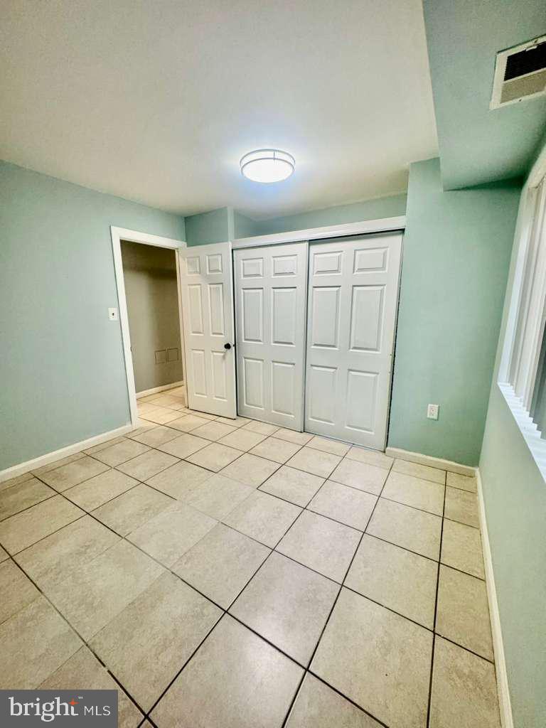 9278 Adelphi Road, Unit 103 Hyattsville, MD 20783 - Photo 15 of 24 a bedroom with a bed and a cabinets
