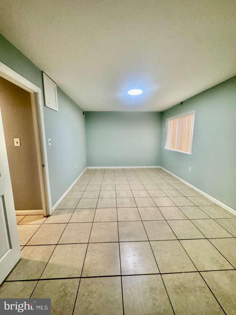 9278 Adelphi Road, Unit 103 Hyattsville, MD 20783 - Photo 16 of 24 a view of an empty room and window