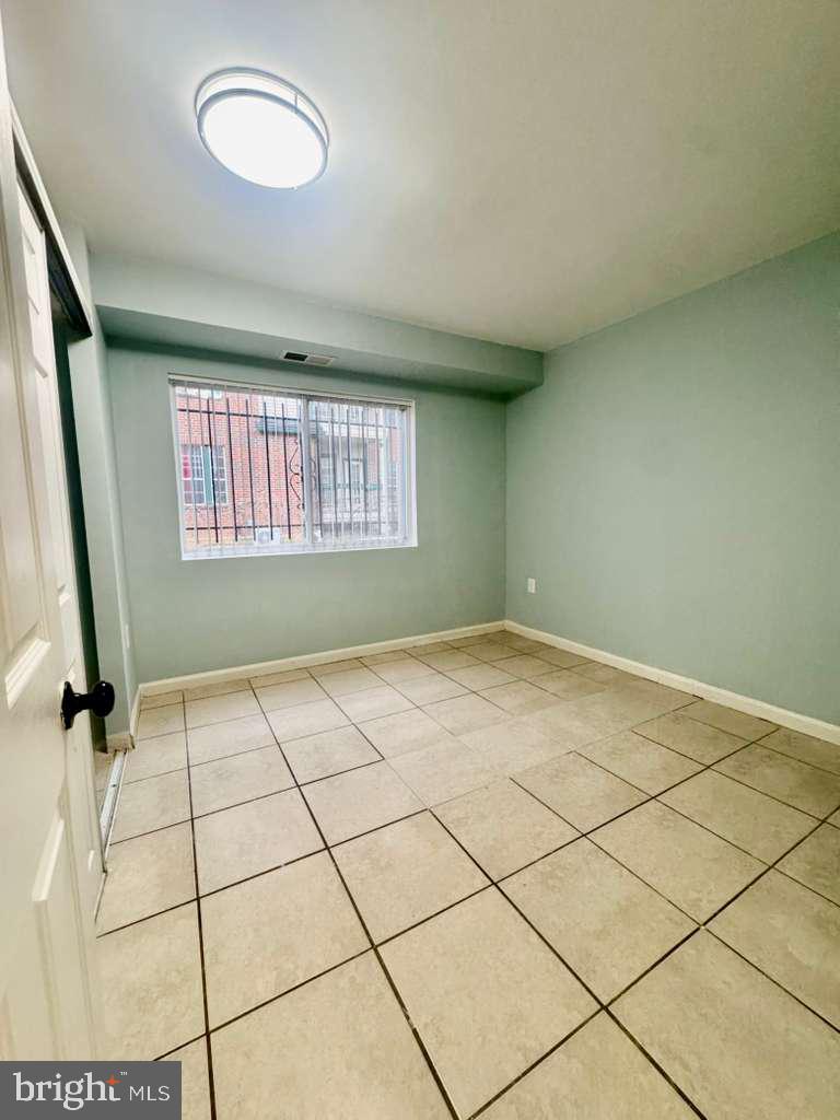 9278 Adelphi Road, Unit 103 Hyattsville, MD 20783 - Photo 17 of 24 a view of an empty room and window