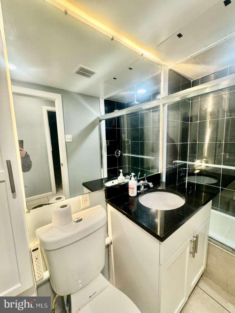 9278 Adelphi Road, Unit 103 Hyattsville, MD 20783 - Photo 19 of 24 a bathroom with a sink and a mirror