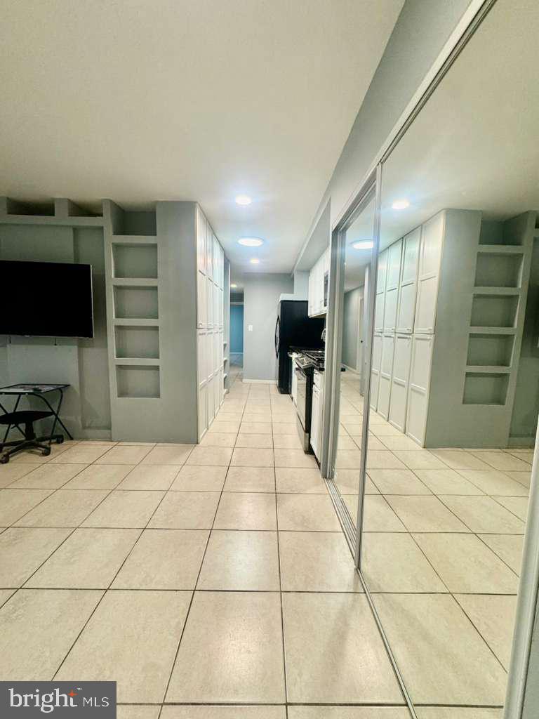 9278 Adelphi Road, Unit 103 Hyattsville, MD 20783 - Photo 3 of 24 a room with a bed and furniture