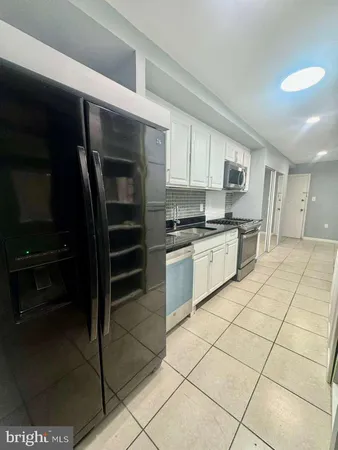 a kitchen with a cabinets and appliances