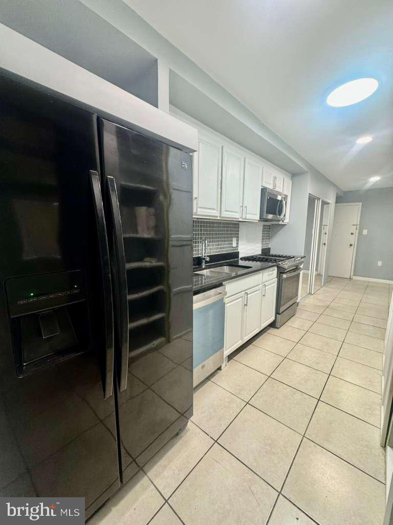 9278 Adelphi Road, Unit 103 Hyattsville, MD 20783 - Photo 4 of 24 a kitchen with a cabinets and appliances