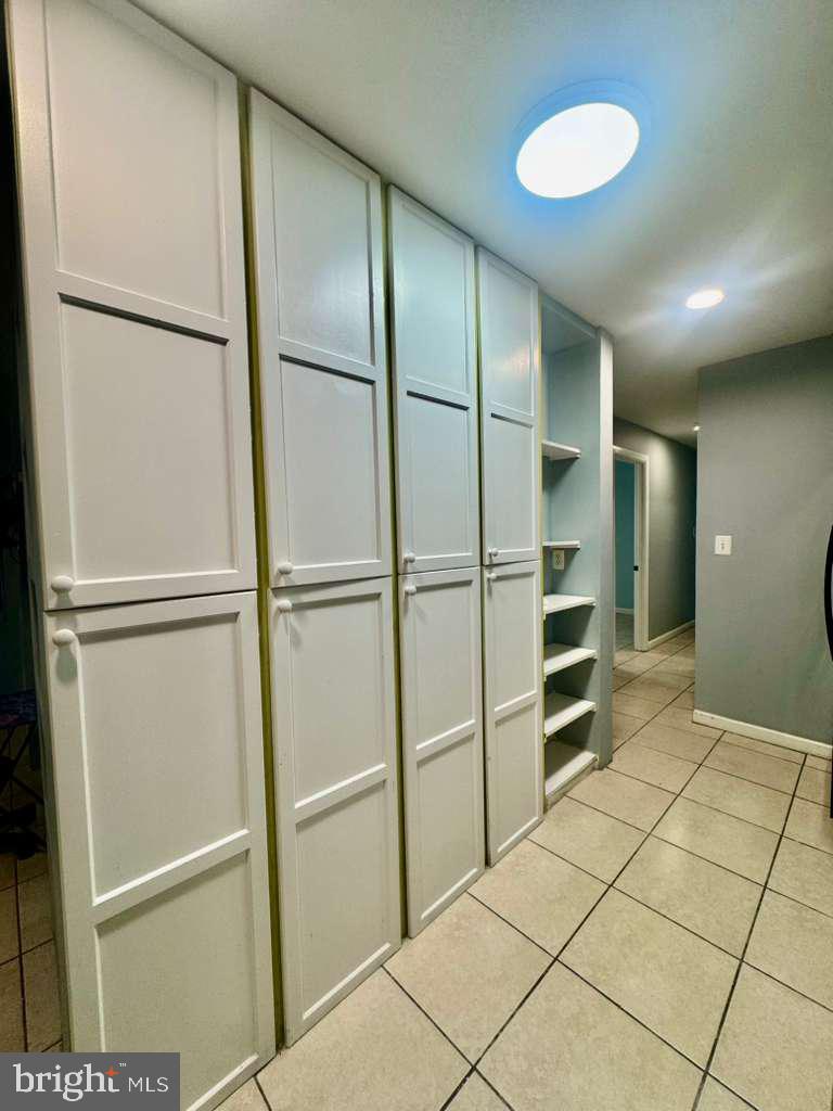 9278 Adelphi Road, Unit 103 Hyattsville, MD 20783 - Photo 6 of 24 a view of walk in closet with empty racks