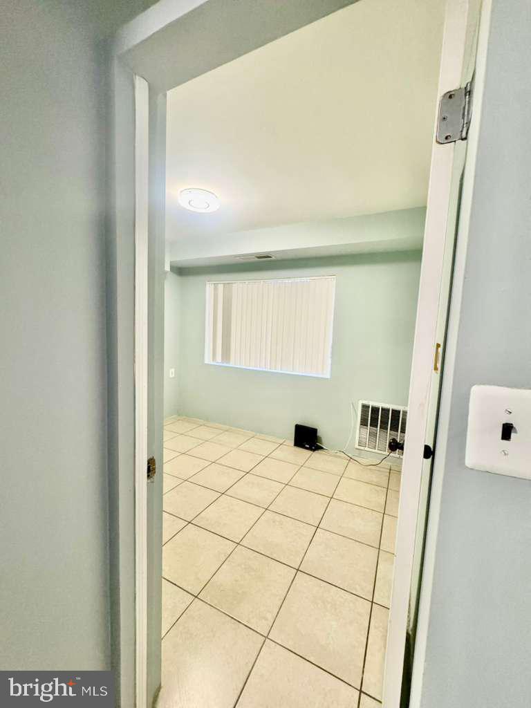 9278 Adelphi Road, Unit 103 Hyattsville, MD 20783 - Photo 8 of 24 a bathroom with a sink and a shower