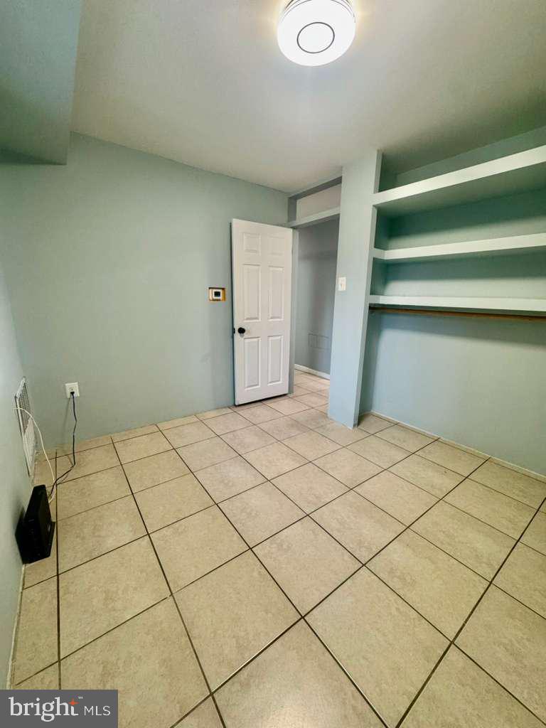 9278 Adelphi Road, Unit 103 Hyattsville, MD 20783 - Photo 10 of 24 a room with a bed and a walk in closet