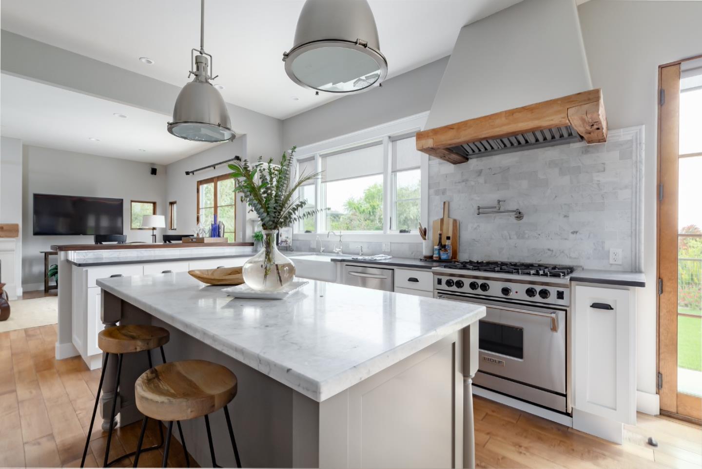 3430 Merrill Road Aptos, CA 95003 - Photo 15 of 49 a kitchen with stainless steel appliances granite countertop a stove a kitchen island a sink dishwasher and a stove with wooden floor