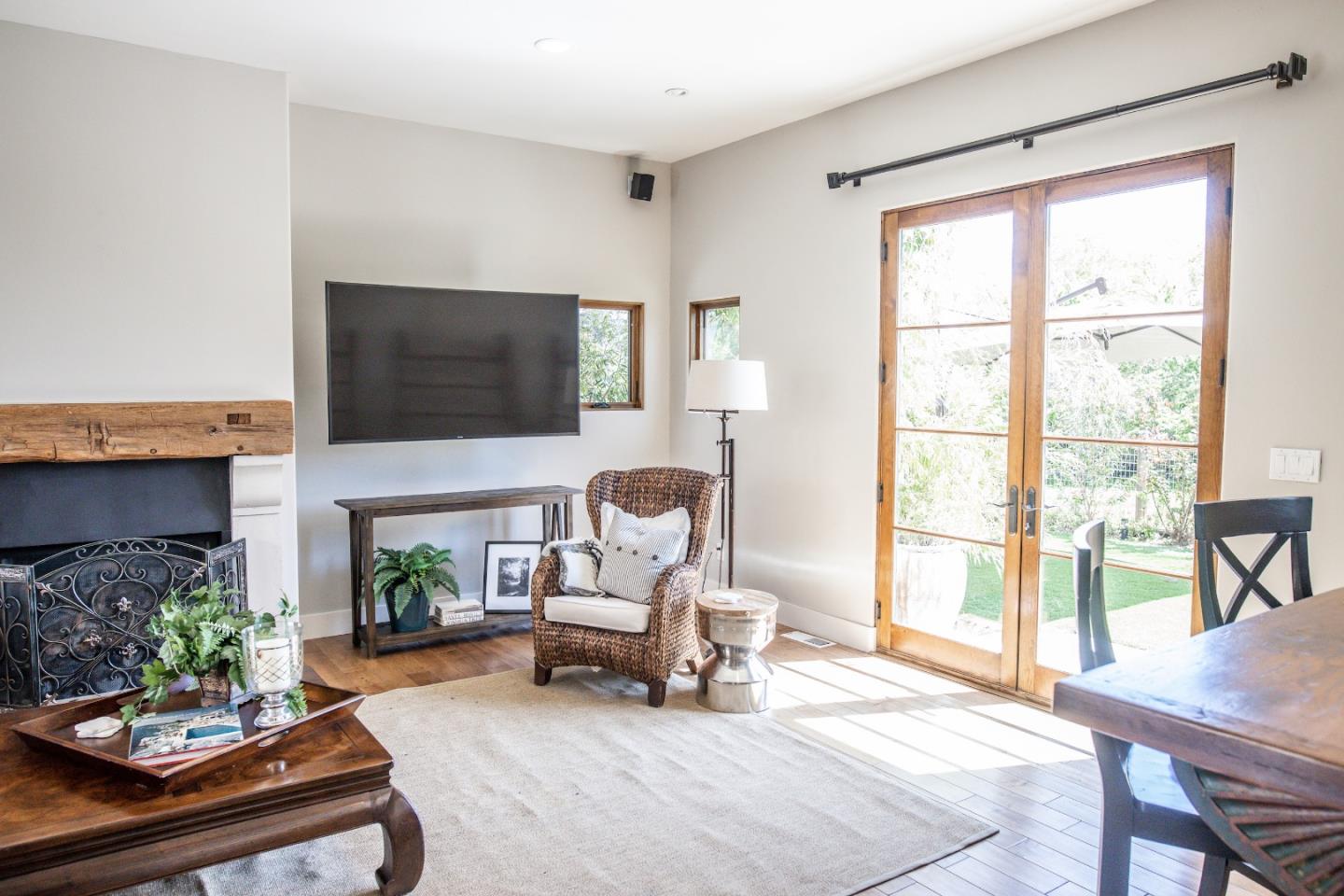 3430 Merrill Road Aptos, CA 95003 - Photo 17 of 49 a living room with furniture a fireplace and a flat screen tv